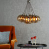 Apollo Seven Light Pendant In Antique Brass Complete With Amber Glass